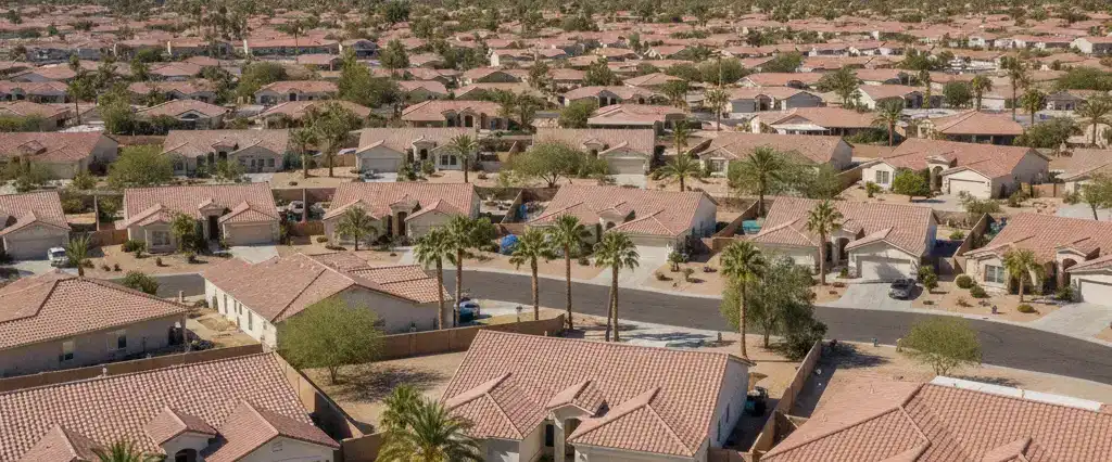 Well-maintained residential rooftops in Avondale, Maricopa County, Arizona, with arid desert mountains in the distance