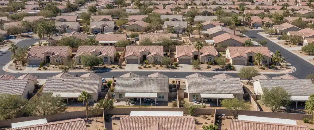 Well-maintained residential rooftops in Glendale, Maricopa County, Arizona, with arid desert mountains in the distance