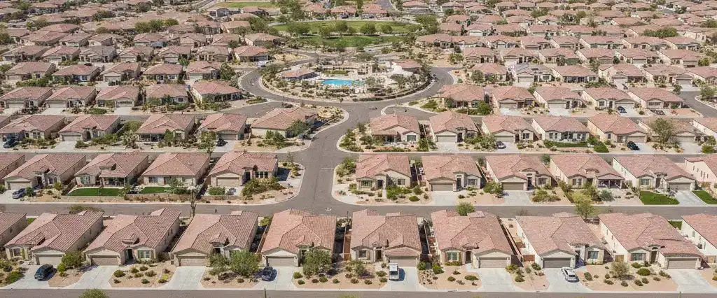 Well-maintained residential rooftops in Goodyear, Maricopa County, Arizona, with arid desert mountains in the distance