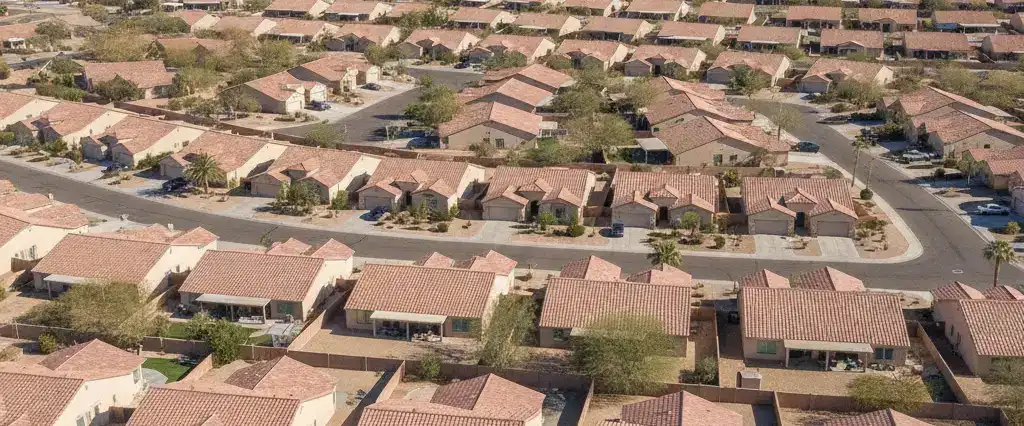 Well-maintained residential rooftops in Peoria, Maricopa County, Arizona, with arid desert mountains in the distance