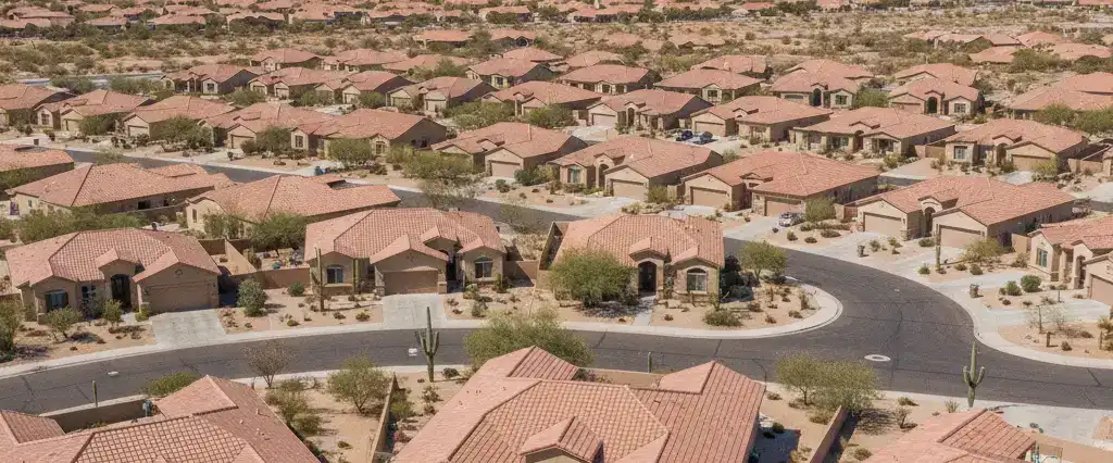 Well-maintained residential rooftops in Marana, Pima County, Arizona, with saguaro-studded desert mountains in the distance