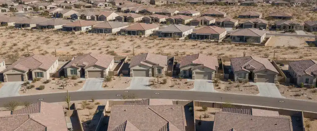 Well-maintained residential rooftops in Maricopa, Pinal County, Arizona, with open Sonoran desert and distant mountains