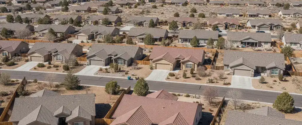 Well-maintained residential rooftops in Prescott Valley, Yavapai County, Arizona, with pine-dotted hills and granite outcrops beyond
