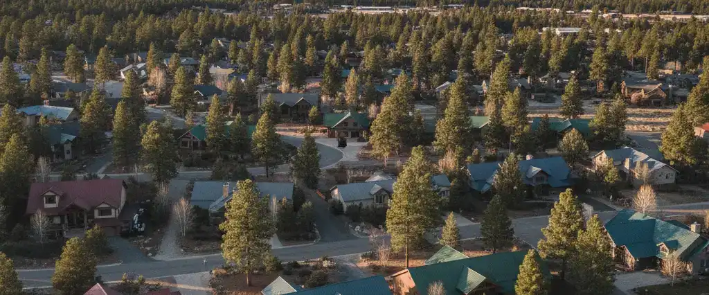 Well-maintained residential rooftops across Coconino County, Arizona, with ponderosa pine and the San Francisco Peaks beyond