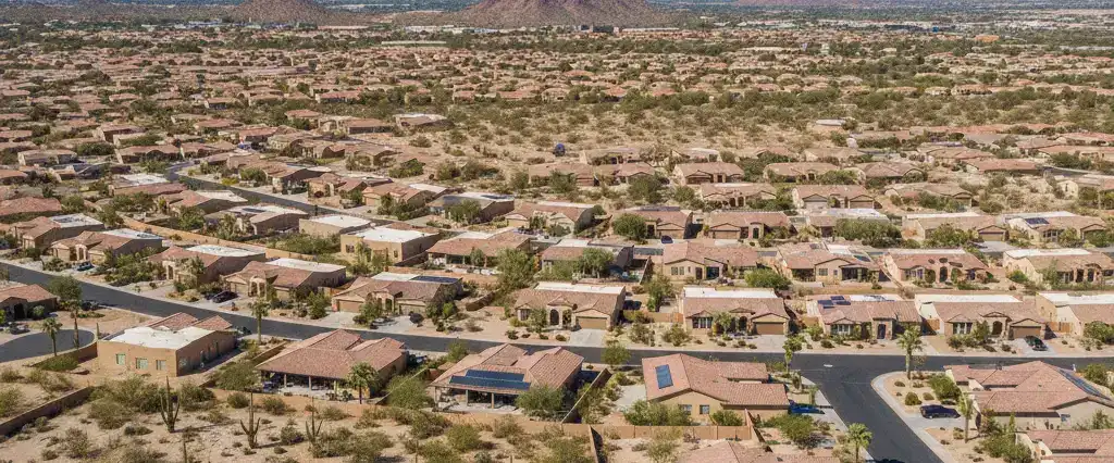 Well-maintained residential rooftops across Maricopa County, Arizona, with arid desert mountains in the distance