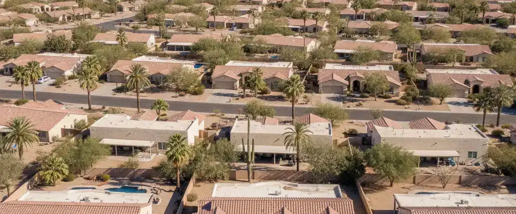 Well-maintained residential rooftops across Arizona, with arid desert mountains in the distance
